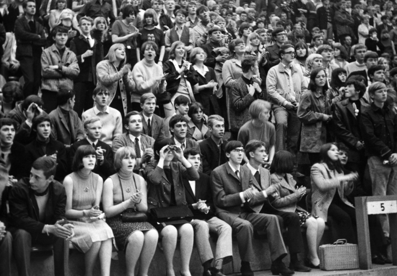 A crowd of people sitting in front of each other.